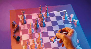 Hand moving a piece on chess board, banner